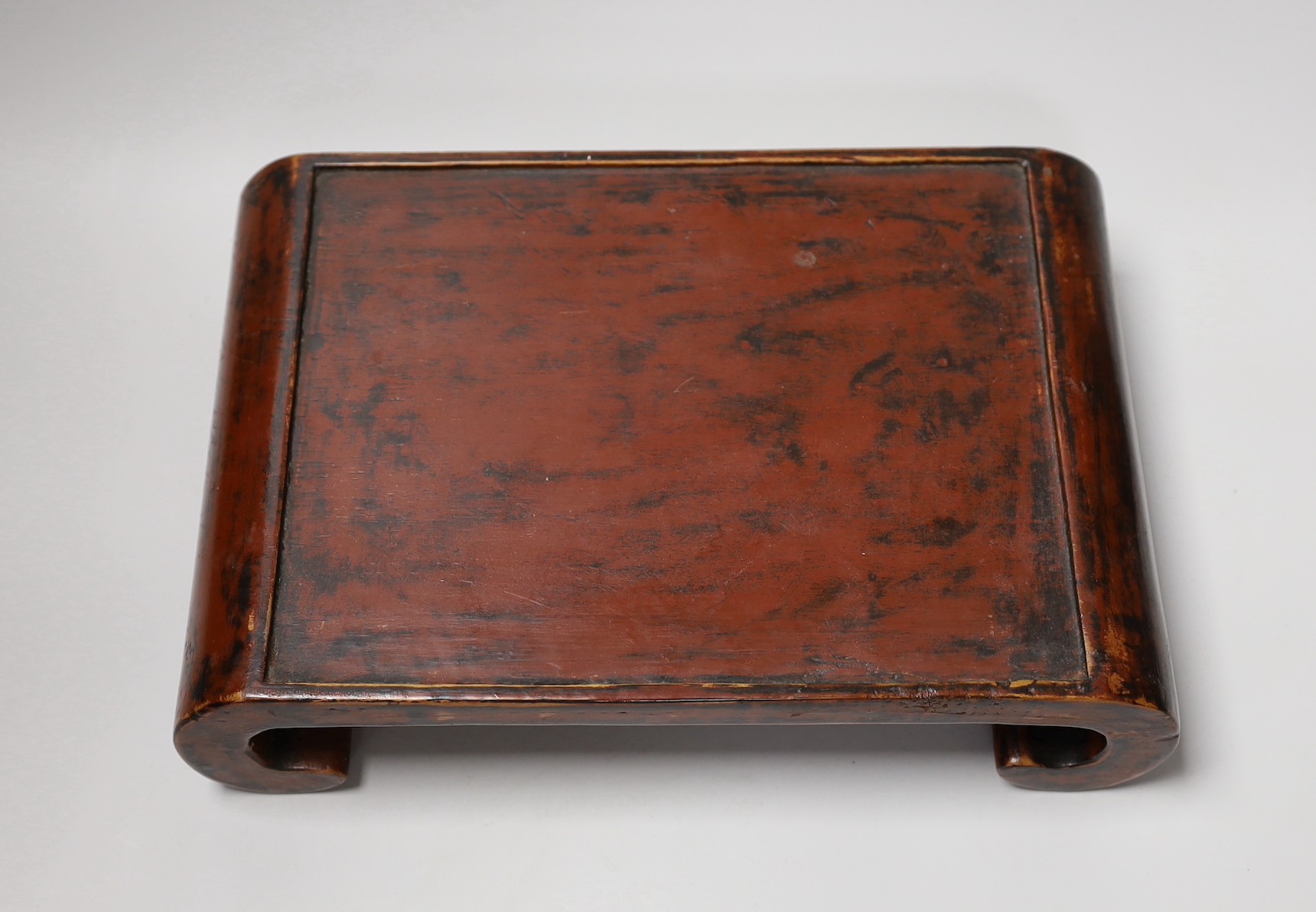 A 19th century Japanese black and red lacquer stand. 32cm wide